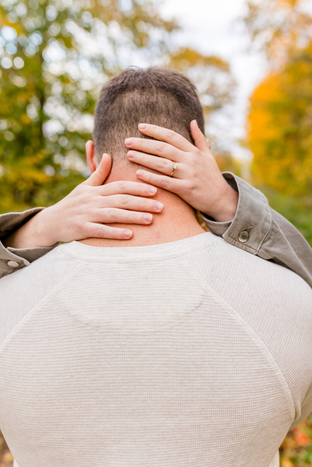 Close-up of engagement rings during Otterville session with fall background