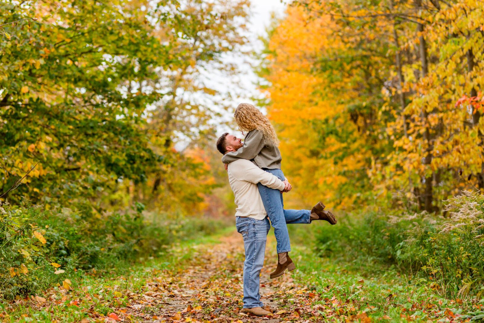 Couple spinning in Otterville engagement session on the trail