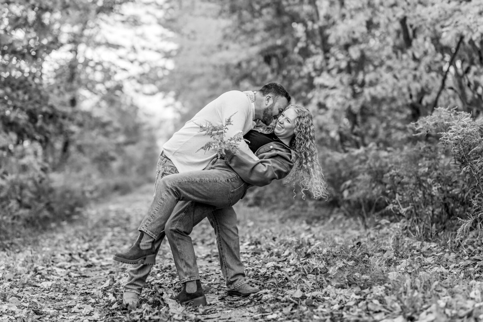 Couple dipping in Otterville engagement session on the trail