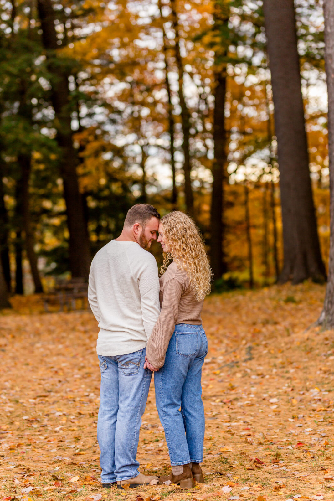 Kissing in Otterville engagement session with golden autumn light